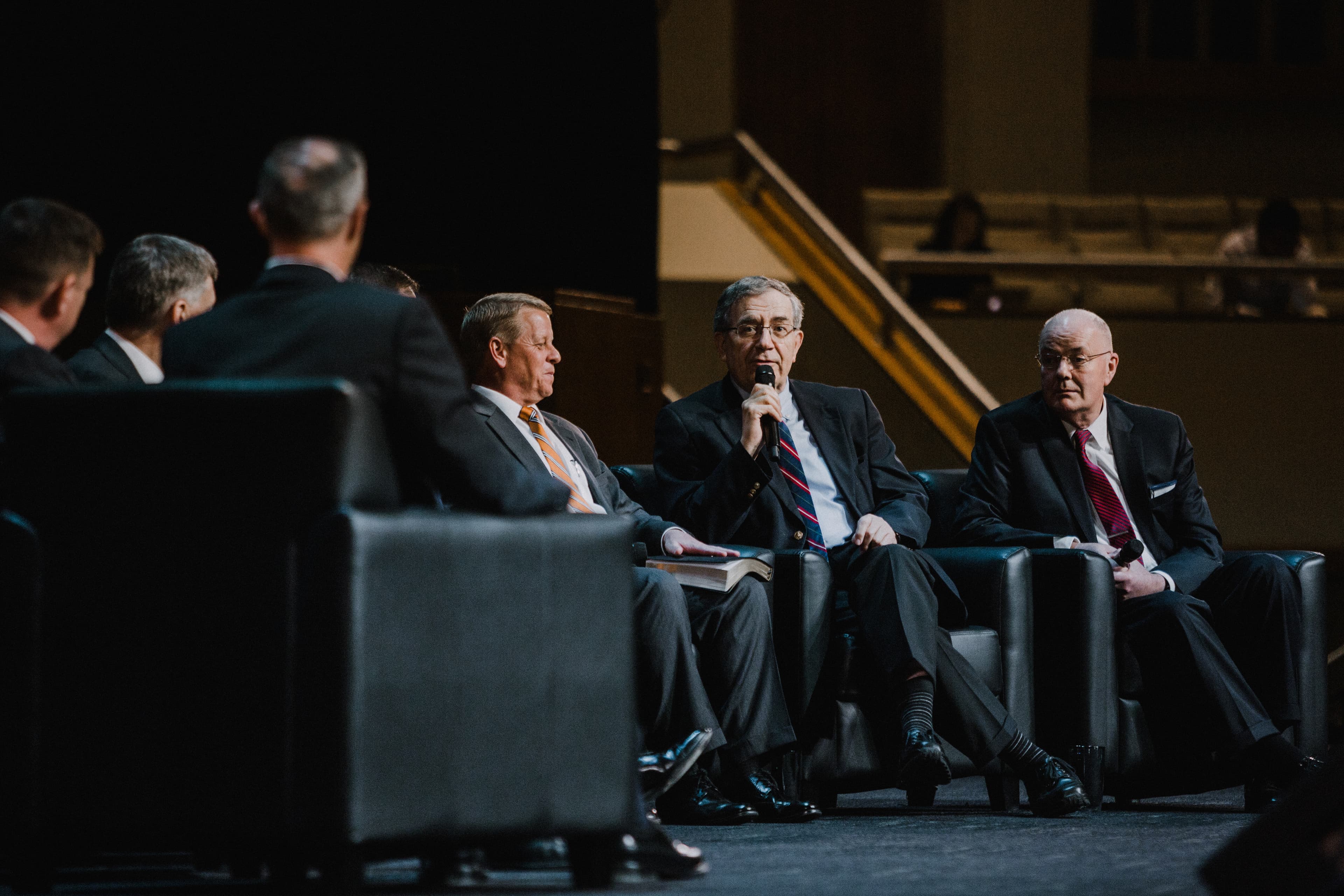 Ligonier teaching fellows speaking into microphone on stage